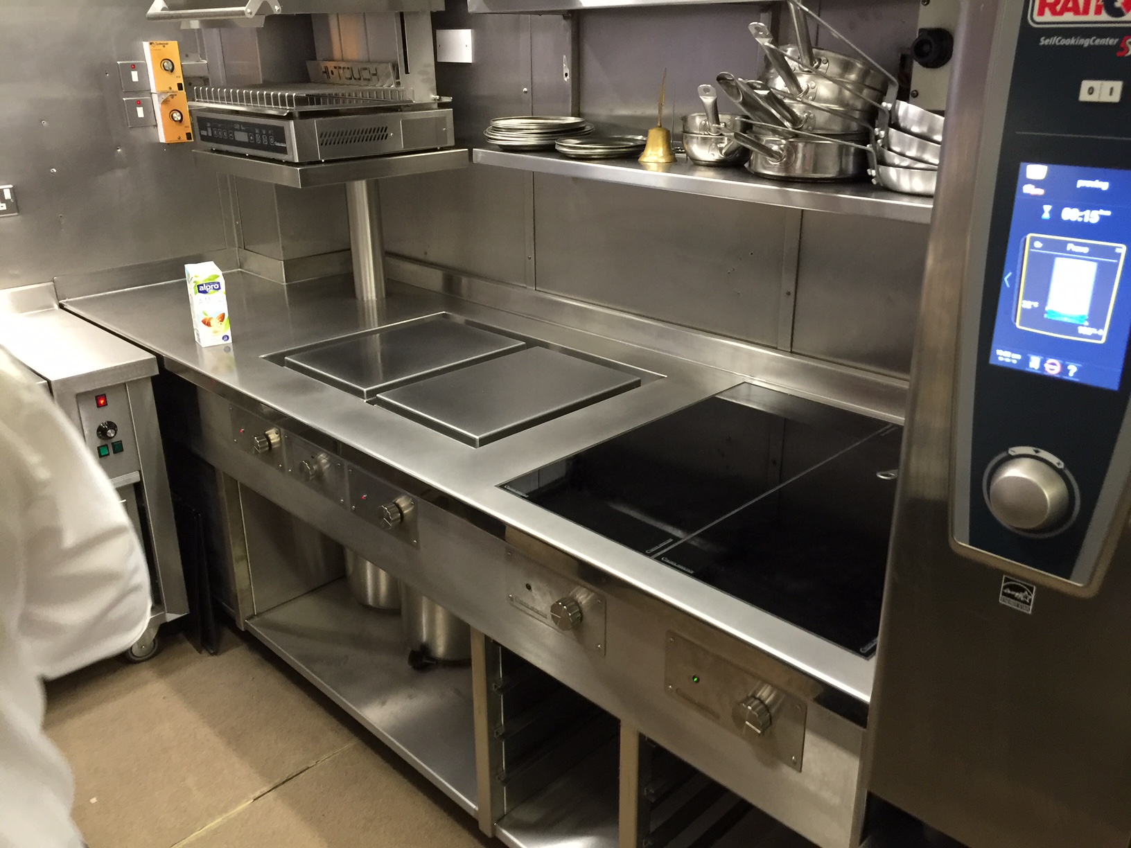 Finished induction cooking suite next to combi oven