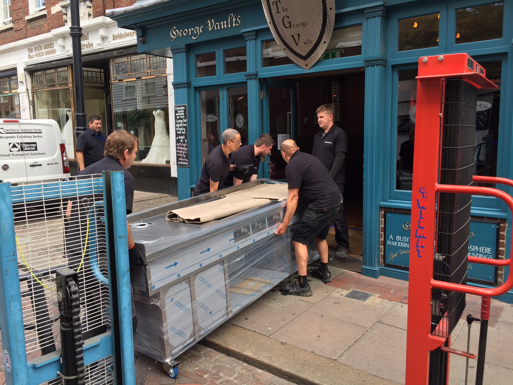 Induction cooker unloaded and being wheeled into the restaurant