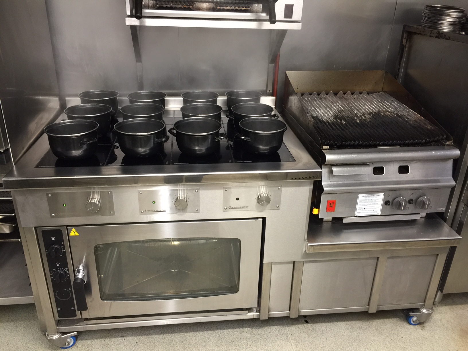 Induction cooking suite with electric oven and gas chargrill